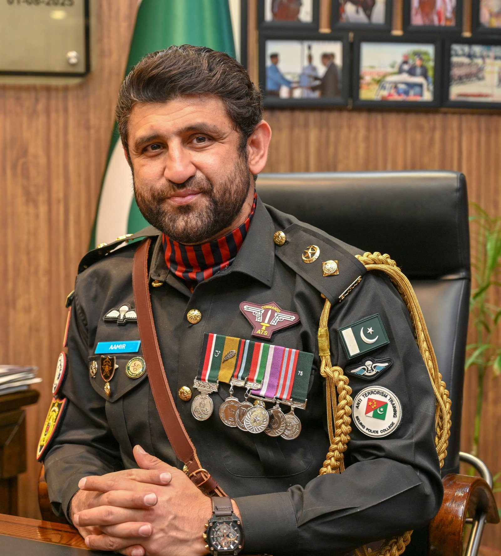 Senior Sindh Police officer at command desk with medals